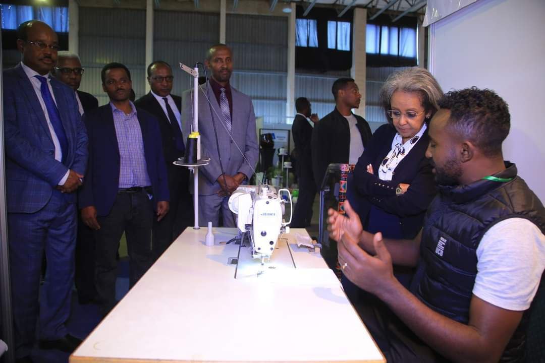 Government officials observing machine demonstration